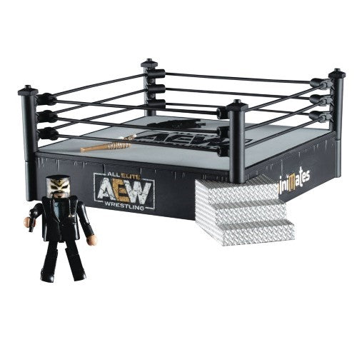 a toy figure standing next to a wrestling ring